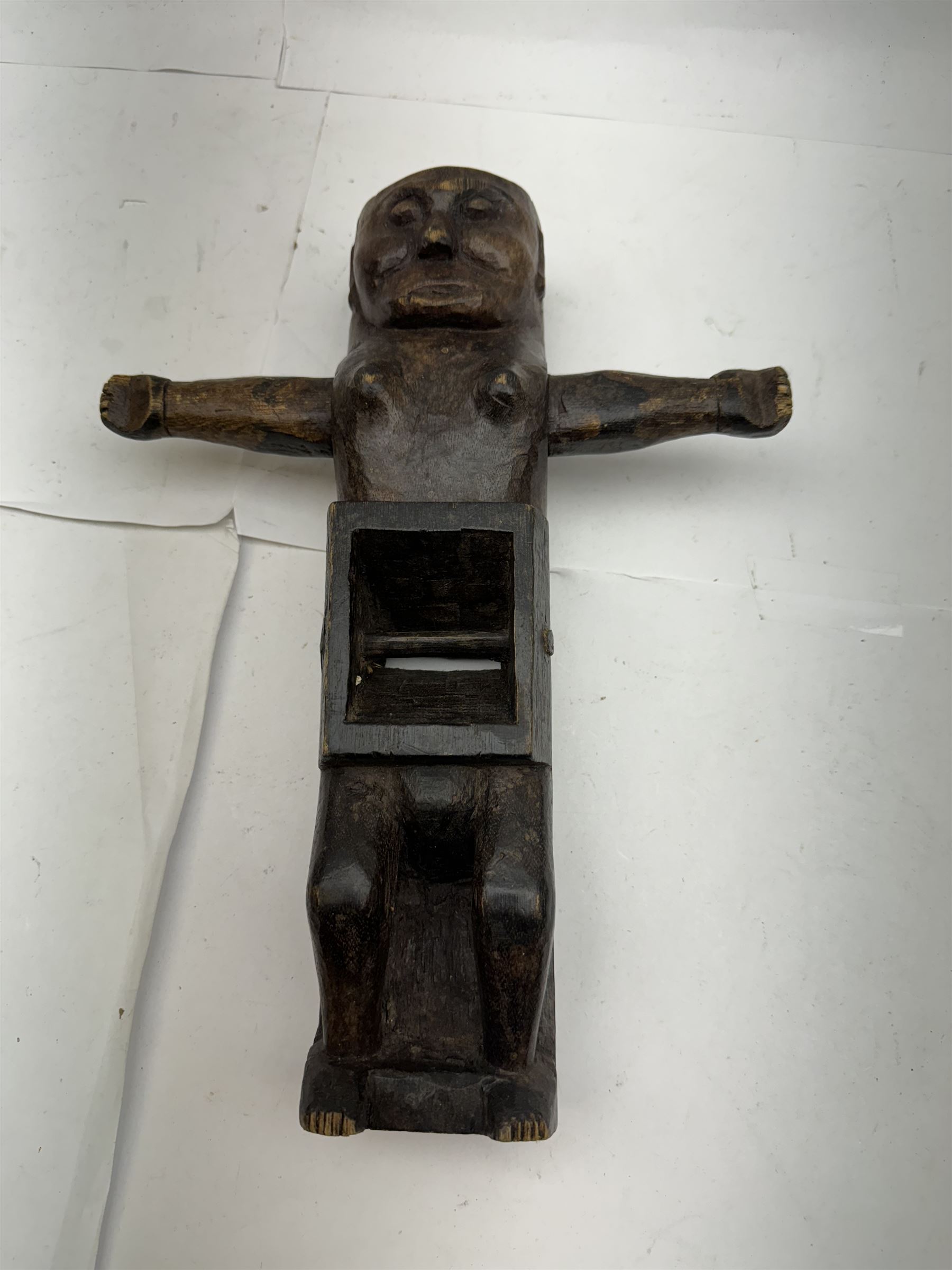 An unusual tribal carved wood figural plane, modelled as a figure with outstretched arms, L31cm