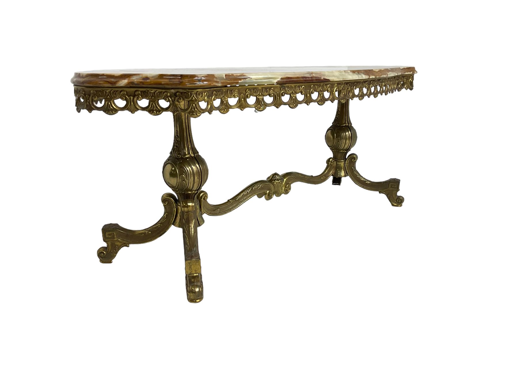 Mid-20th century Italian design Onyx and gilt serpentine coffee table, pierced gilt metal frieze with scrolling decoration, raised on twin end supports with globular turning and foliate decoration united by shaped scroll stretcher