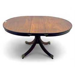 Regency design mahogany extending dining table, circular top with reeded edge and pull-out...