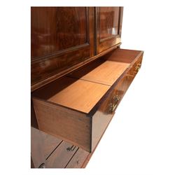 Victorian mahogany linen-press, moulded cornice over two figured panelled doors, the interior fitted with five slides and hanging rail, four long drawers below 