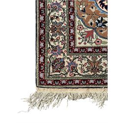 Indo-Persian indigo ground rug, the floral design peach medallion surrounded by trailing and interlaced branches and flower heads, the main border decorated with repeating stylised plant motifs within floral guard stripes 