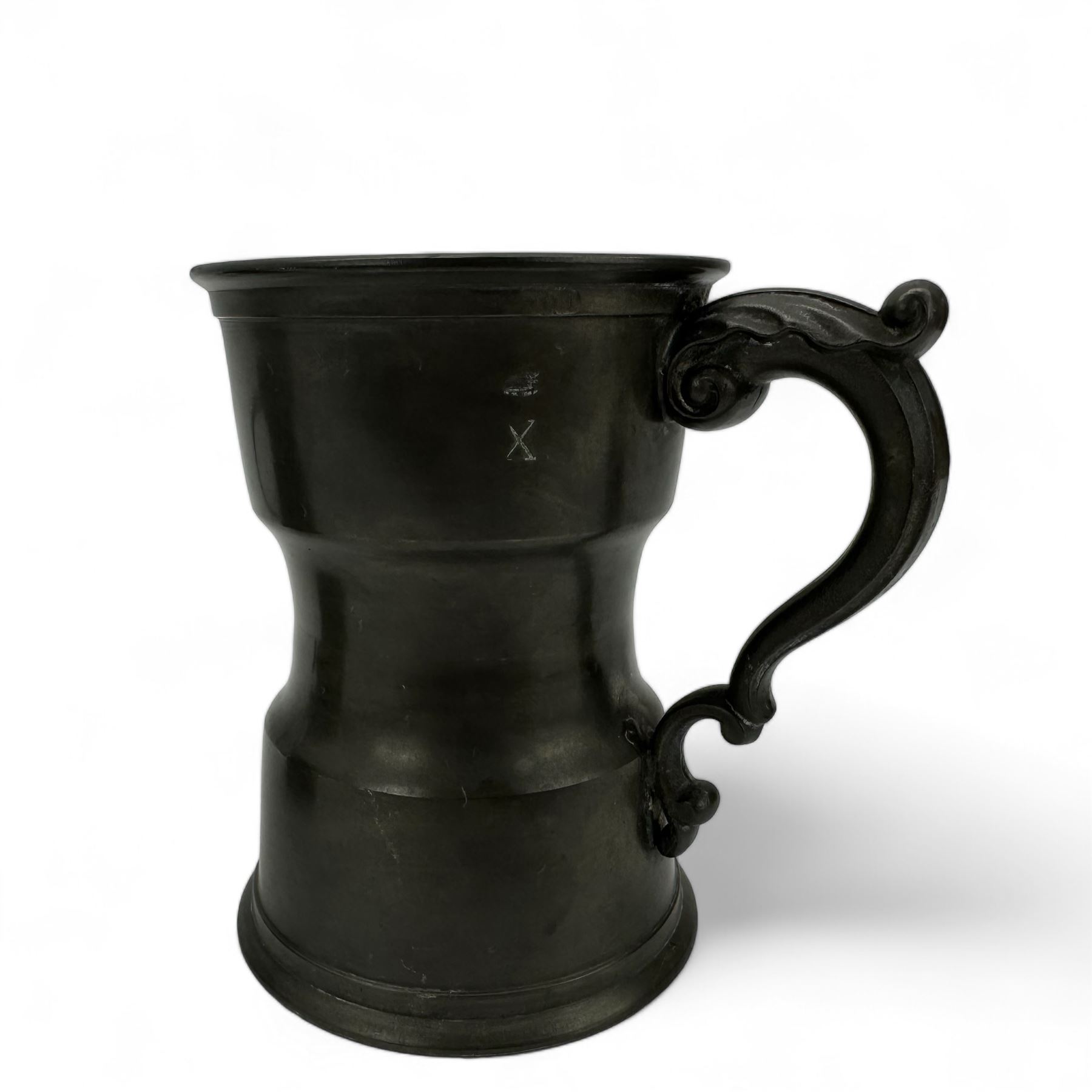 18th century pewter tankard, circa 1770, with scroll handle and acanthus leaf thumbpiece, touch marks and crowned X, H13cm, together with a Victorian 1/2 pint pewter measure, touch marks, weights and measures inspector verification mark (2)