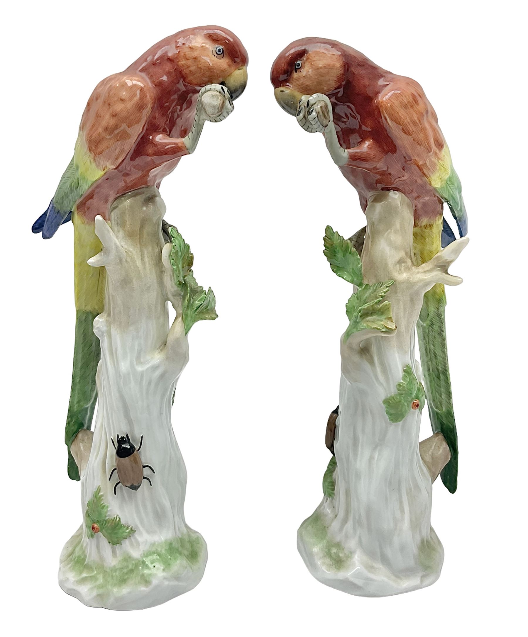 Pair of 20th century Dresden figures, modeled as parrot perched upon a tree stump, with makers mark beneath, H32cm 