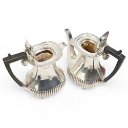 Silver three piece coffee set comprising coffee pot, hot water jug and sugar box each with half body fluted decoration, gadrooned edge, ebonised handles and ball feet, Sheffield 1927 Maker William Hutton & Son Ltd