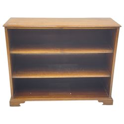 20th century mahogany open bookcase, fitted with two shelves, on bracket feet