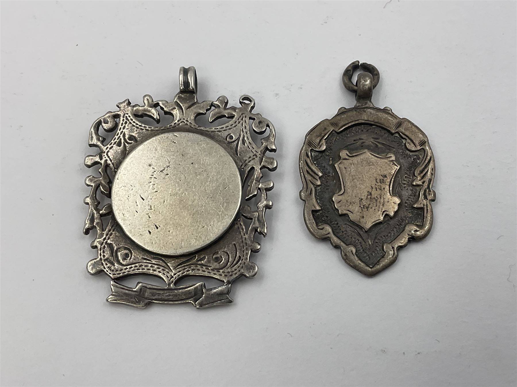 Ten early 20th century silver cartouche fobs, to include a shield shaped example embossed with PSW 1918, hallmarked Birmingham 1918, and two double sided examples, all hallmarked with various dates and makers
