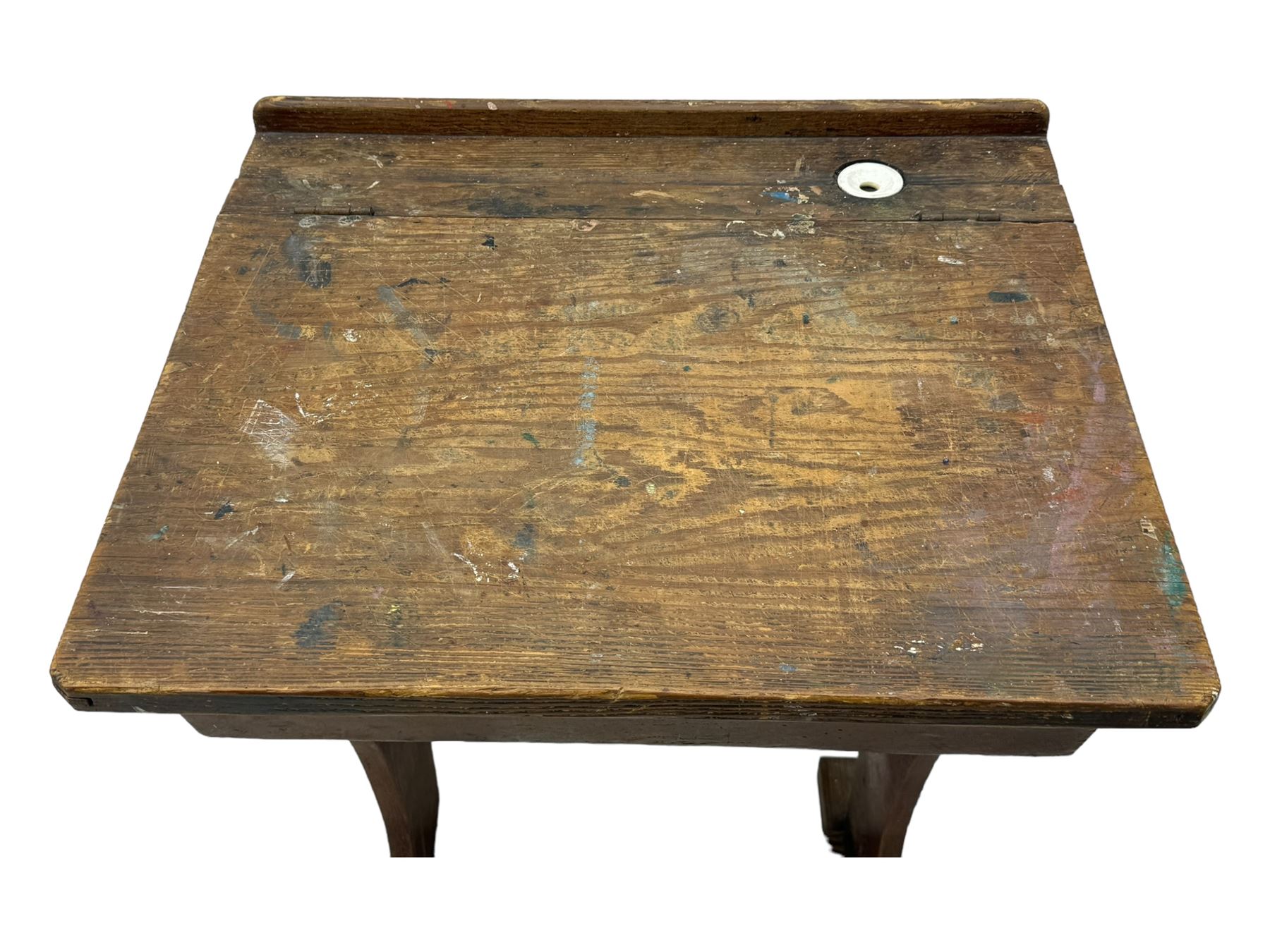 Three pitch pine school desks, each with rectangular lift-top with recessed ink well enclosing storage compartment, on trestle supports joined by stretcher