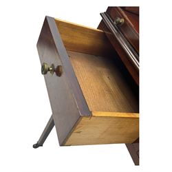 Edwardian inlaid mahogany roll-top desk, cylindrical lid enclosing fitted interior with pigeonholes, drawers and retractable writing surface, over two drawers with brass pull handles, on tapered supports with brass and ceramic castors