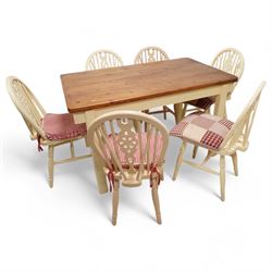 20th century pine kitchen dining table, stained top over cream painted base (W133cm D81cm H77cm); and six painted wheel-back chairs (H89cm)