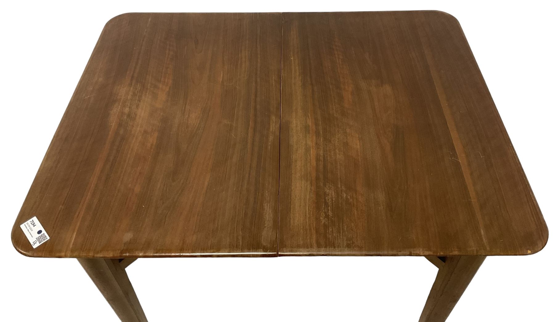 Mid-20th century teak extending dining table, rectangular top with rounded corners, raised on shaped tapering supports united by X-stretcher, with additional leaf