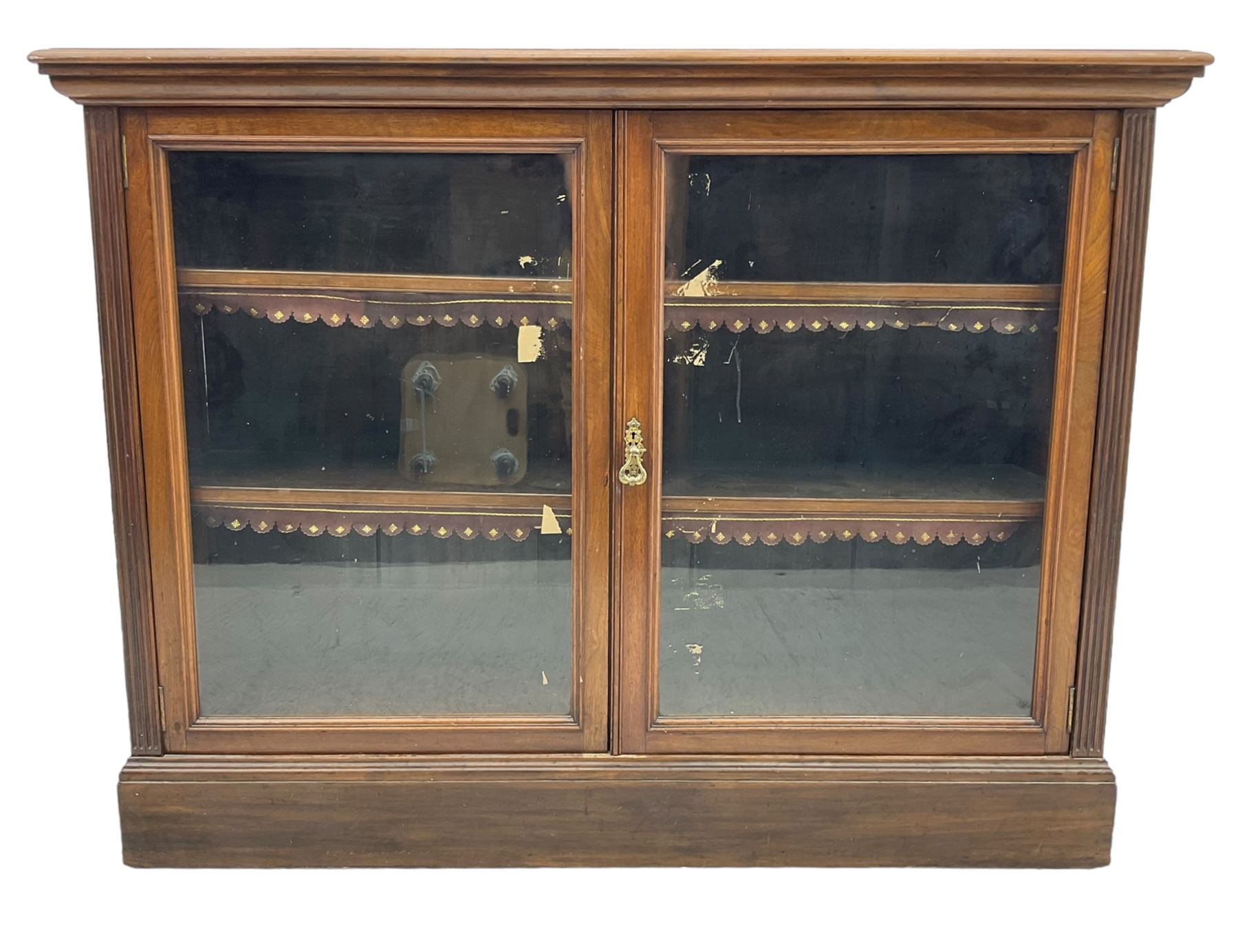 Phillips & Sons Ltd Bristol - Victorian mahogany glazed bookcase, projecting moulded cornice over two glazed doors, enclosing two shelves with scalloped edging, raised on a plinth base