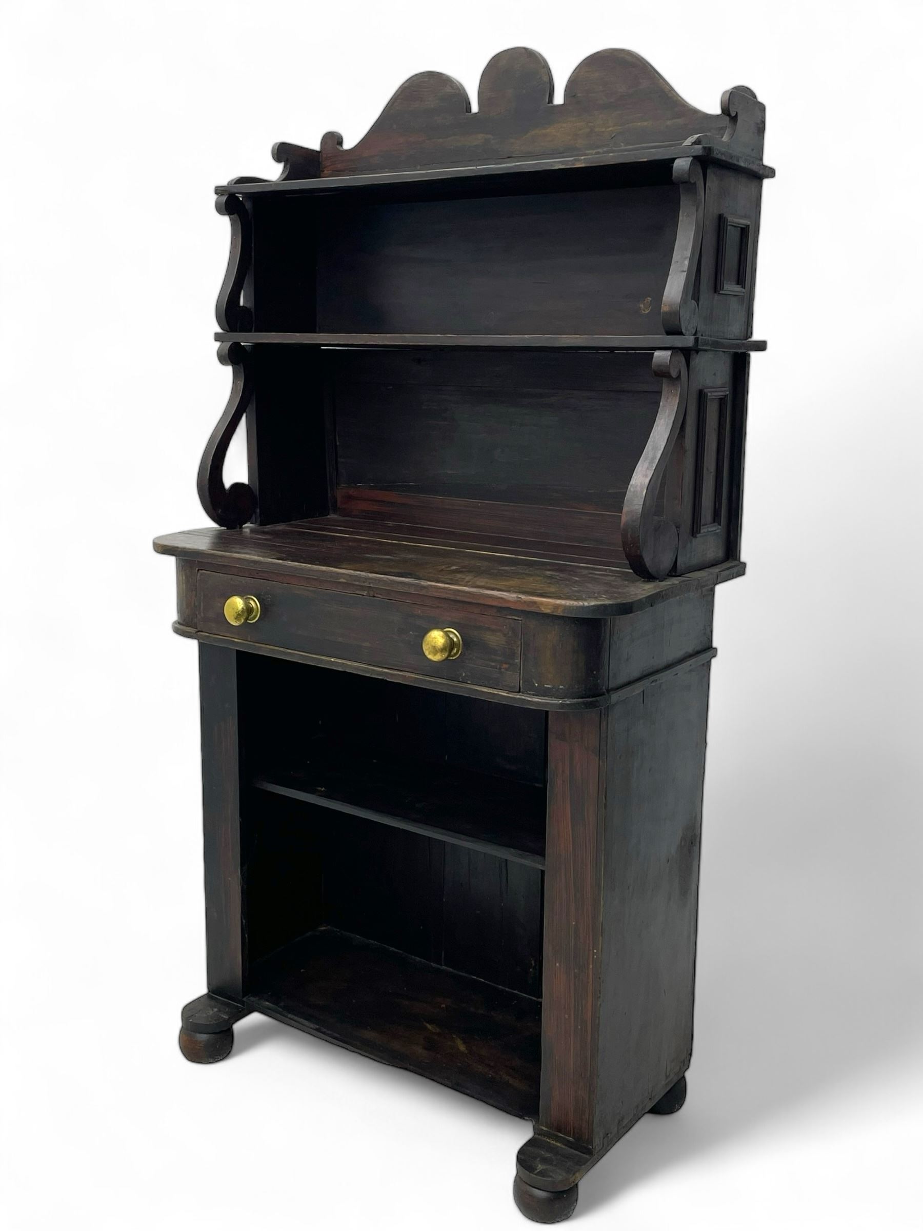 Victorian scumbled pine chiffonier, raised shaped back fitted with two shelves on S-scroll supports, rectangular top with rounded corners over single frieze drawer and open shelf, on projecting rounded sledge platforms and compressed bun feet, scumbled to resemble rosewood 