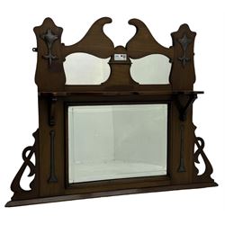 Arts & Crafts period walnut overmantel mirror, shaped pediment over shelf, rectangular bevelled mirror plate within applied mouldings, shaped and pierced corner brackets, decorated with shaped copper mounts 