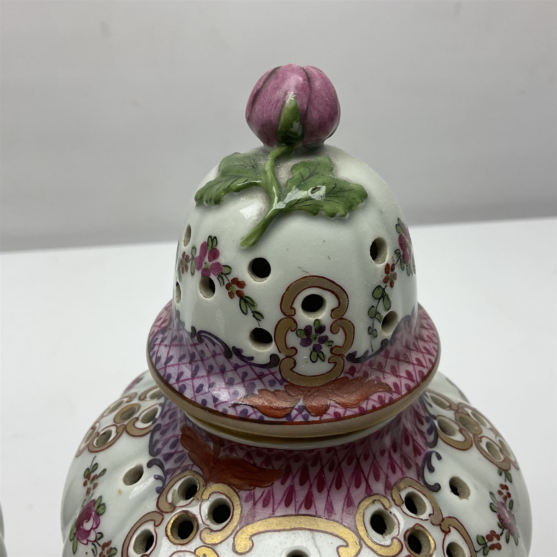 Pair of pot pourri vases and covers, decorated with floral sprigs and with rose finials to the covers, H24cm