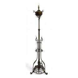 Victorian brass converted oil lamp stand, telescopic stem with scrolled uprights terminating to scrolled feet, dished base decorated with scrolling cast metal work and grotesque masks 