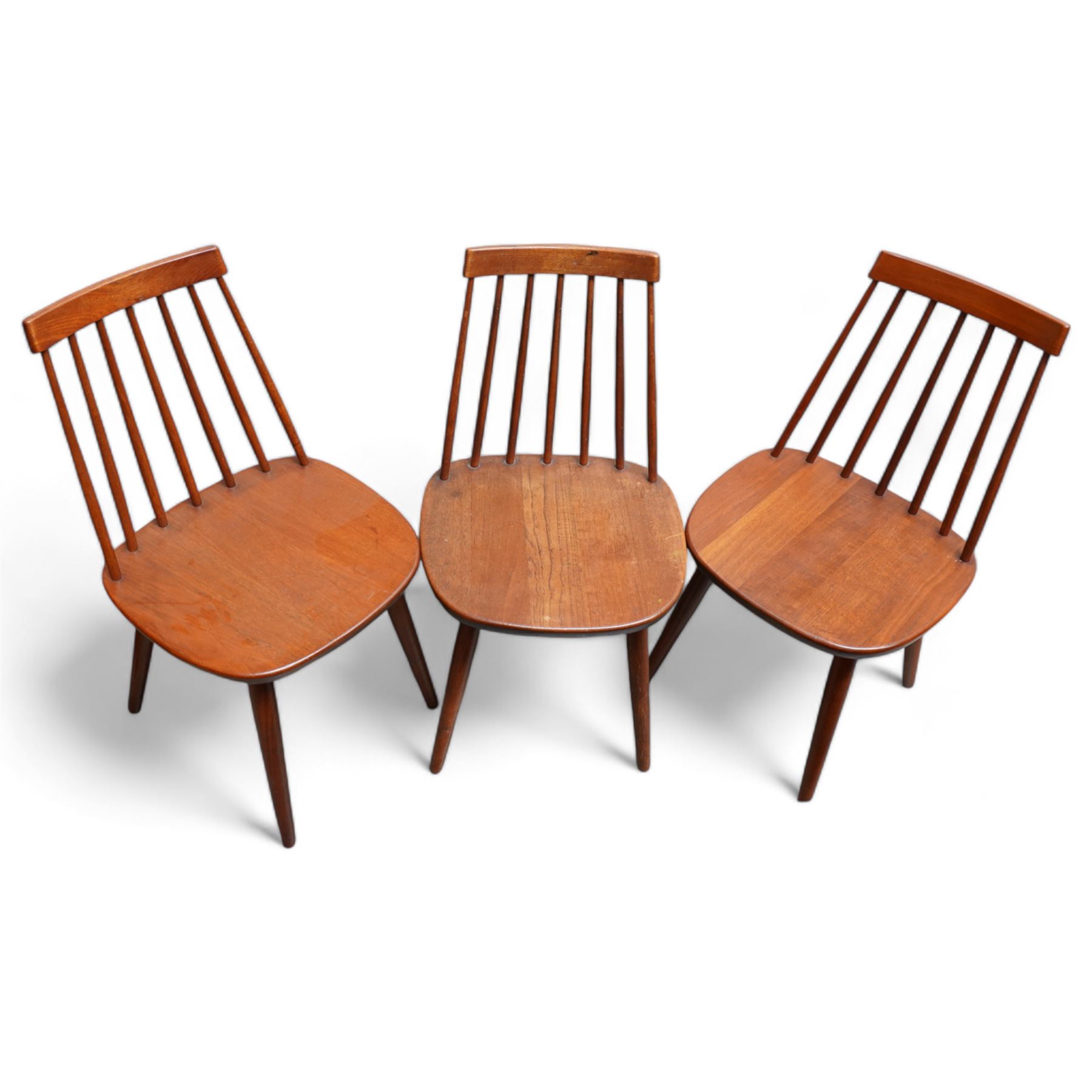 Set of three mid-20th century Swedish teak stick-back chairs, raised on tapering supports