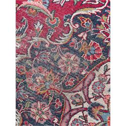 Large Persian Kashan crimson ground carpet, central floral medallion surrounded by swirling leafy branches and palmettes, enclose by floral pattern spandrels, the indigo border with overall scrolling design decorated with palmettes, within guard stripes 