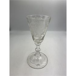 18th century large baluster wine glass, circa 1745, the funnel bowl decorated with a crest and foliate, to a knopped stem and deep domed  and upturned foot, H20cm