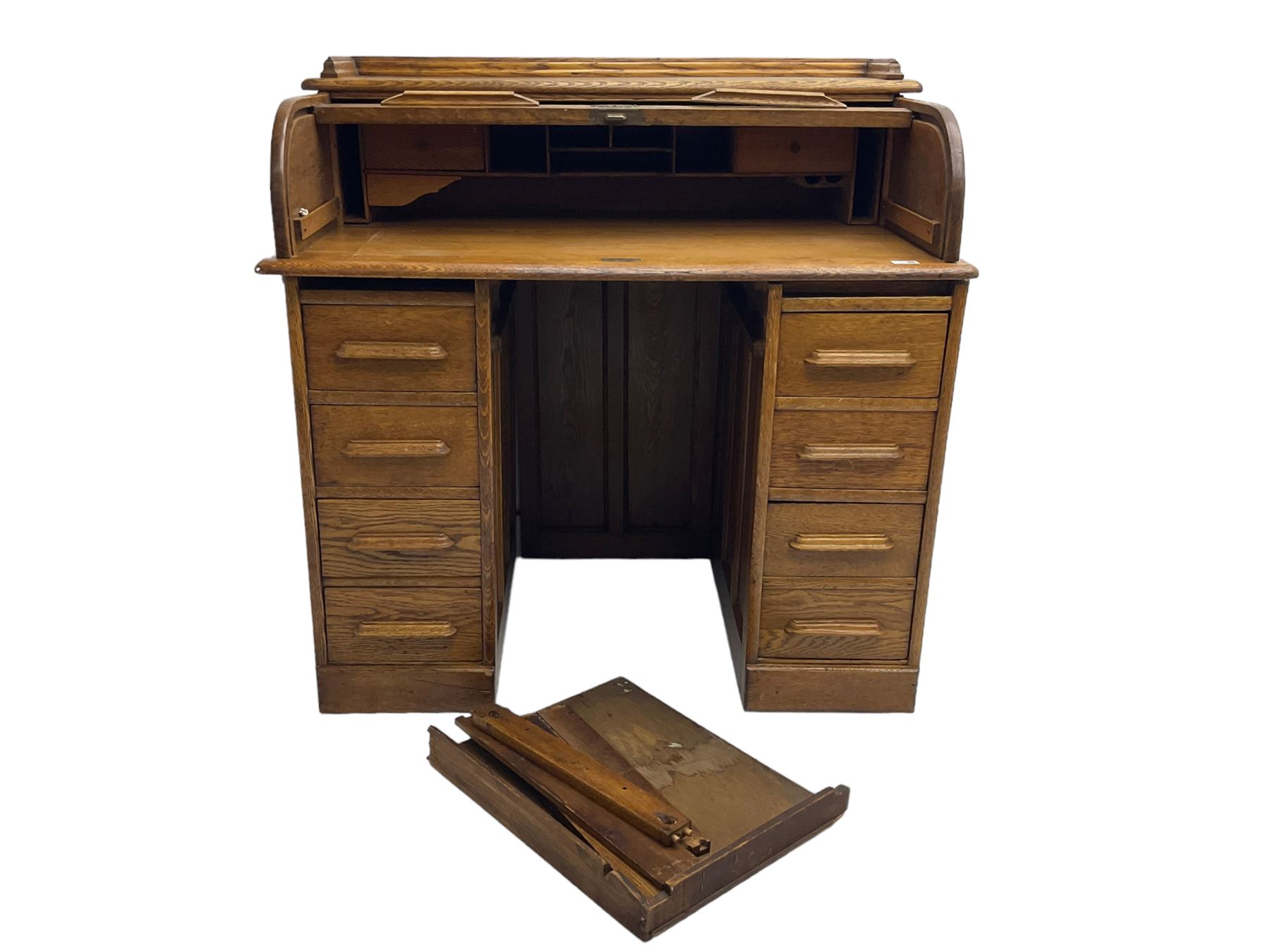 Early 20th century oak twin pedestal desk, tambour roll top enclosing fitted interior, eight drawers, on plinth base