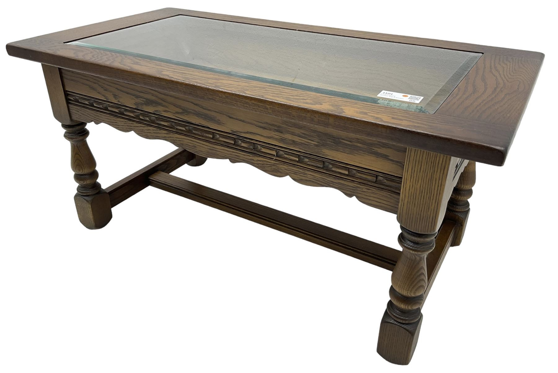 Old Charm - oak coffee table, rectangular top with glass inset over carved scalloped apron, on turned square supports connected by H-stretcher