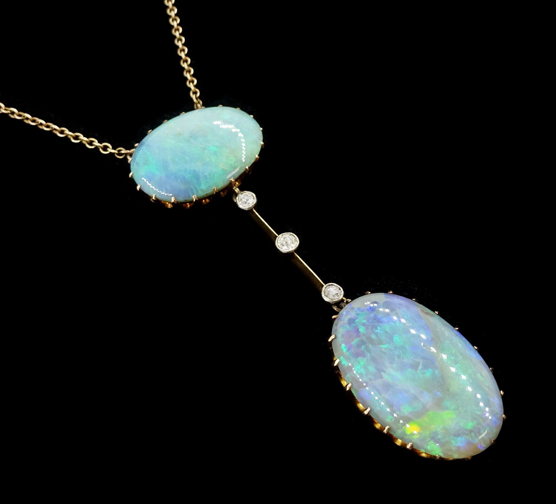 Early 20th century gold opal and diamond pendant necklace, two oval cabochon cut opals spaced by three milgrain set old cut diamonds, total opal weight approx 16.85 carat