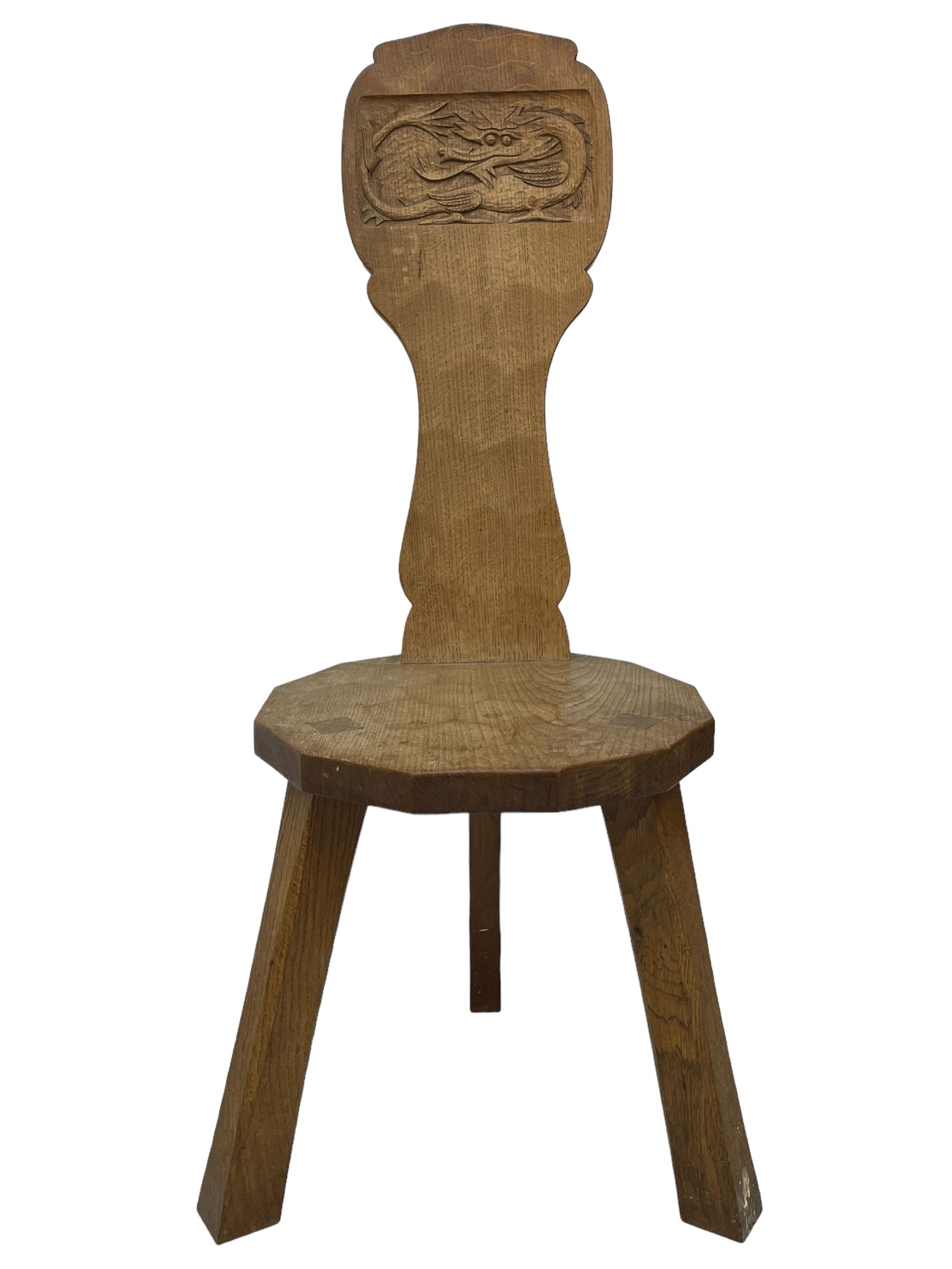 Gnomeman - two oak spinning or hall chairs, shaped splat backs, one carved with Yorkshire Rose, the other with mythical dragon, decagon seats on chamfered square tapering supports, each carved with gnome signature, by Thomas Whittaker, Littlebeck