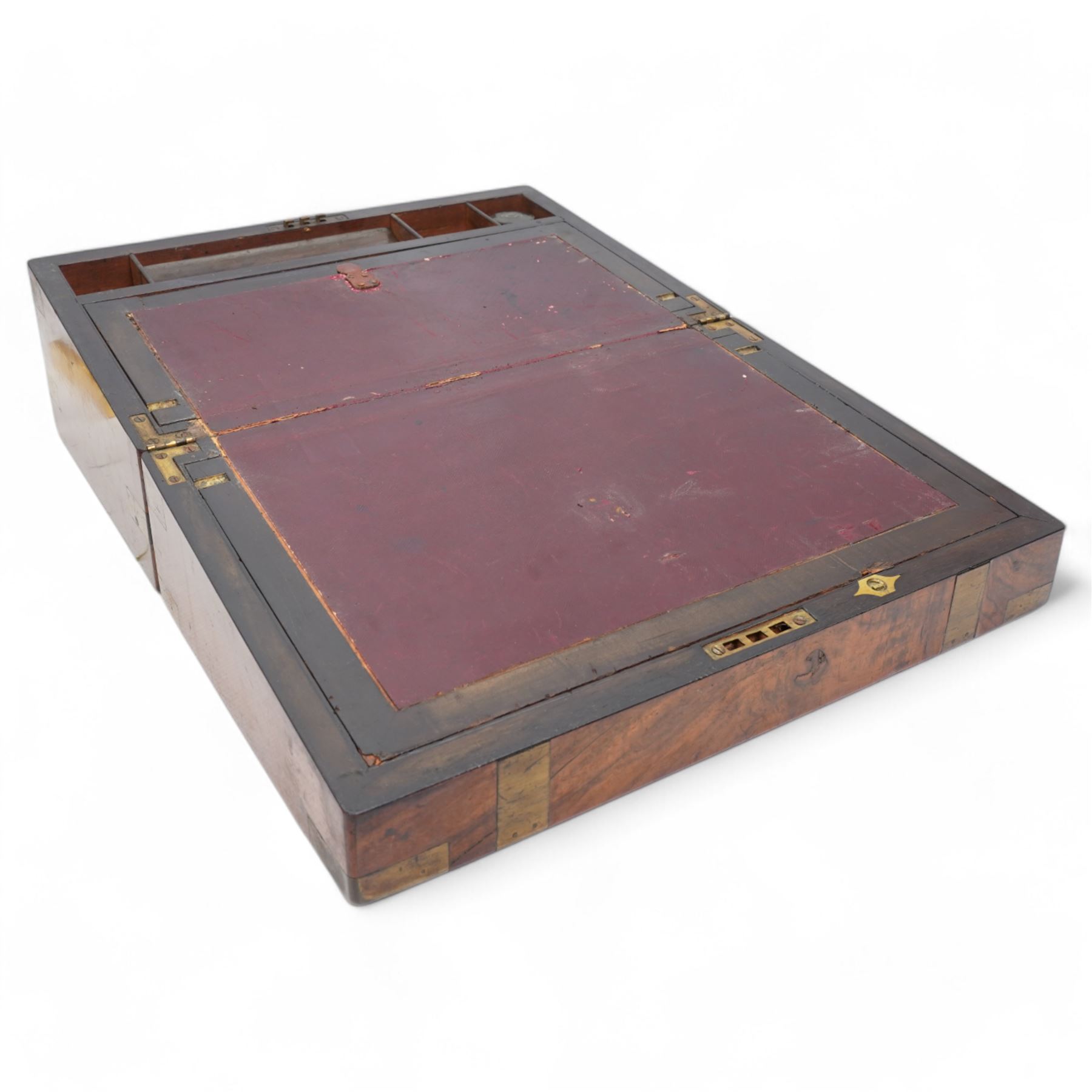 Victorian brass bound walnut writing slope, with brass escutcheon to the hinged cover, revealing an oxblood leather slope, and pen tray flanked by two spaces for inkwells, lacking one, the slope lifting to reveal two other compartments H18cm x W40cm; together with a carved meerschaum pipe depicting Hermes and a Ram, in original case (2)