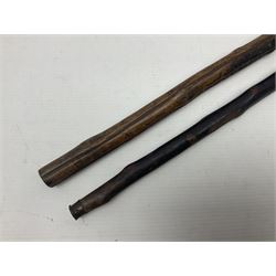 Two wooden walking sticks, both with comparts that would have housed horse measures, H88cm