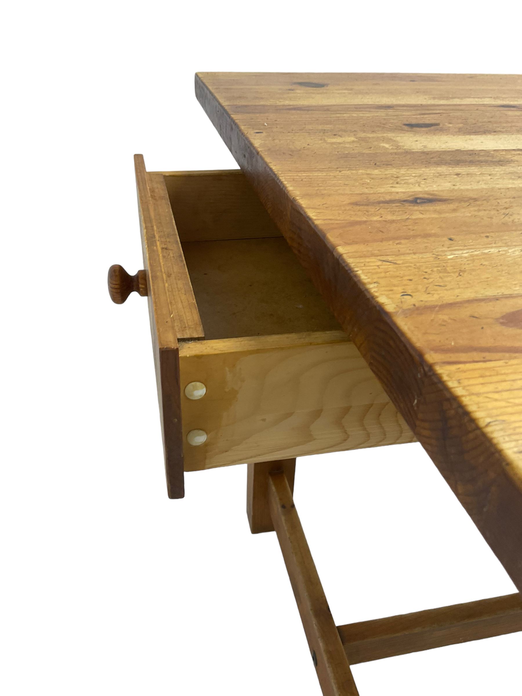 Traditional waxed pine kitchen or dining table, rectangular top over square supports united by H-stretcher