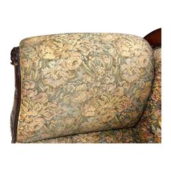 Victorian Aesthetic Movement mahogany framed chaise longue, shaped carved back over acanthus scrolled arm terminal, upholstered in floral patterned tapestry fabric with sprung seat, on turned and fluted supports with castors