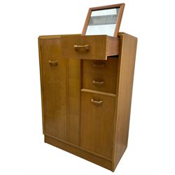 G-Plan - mid 20th century teak tallboy or combination wardrobe, left side with full-height hanging cupboard, right side with three drawers, the top fitted with vanity mirror, above cupboard with shelves, raised on a plinth base