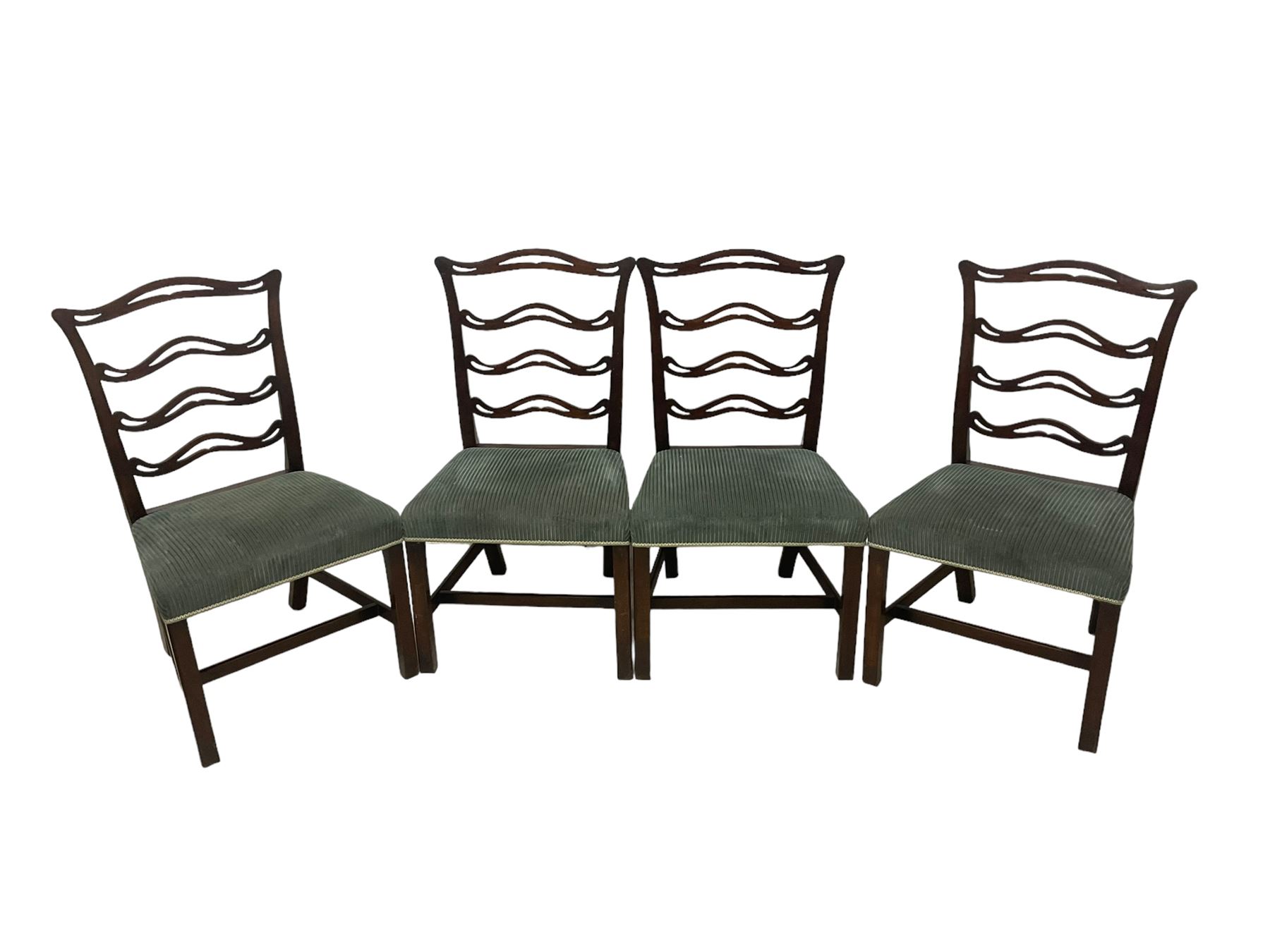 Set of twelve (10+2) Chippendale revival stained beech dining chairs, pierced waived ladder backs with over-stuffed over seats, on square moulded supports joined by stretchers