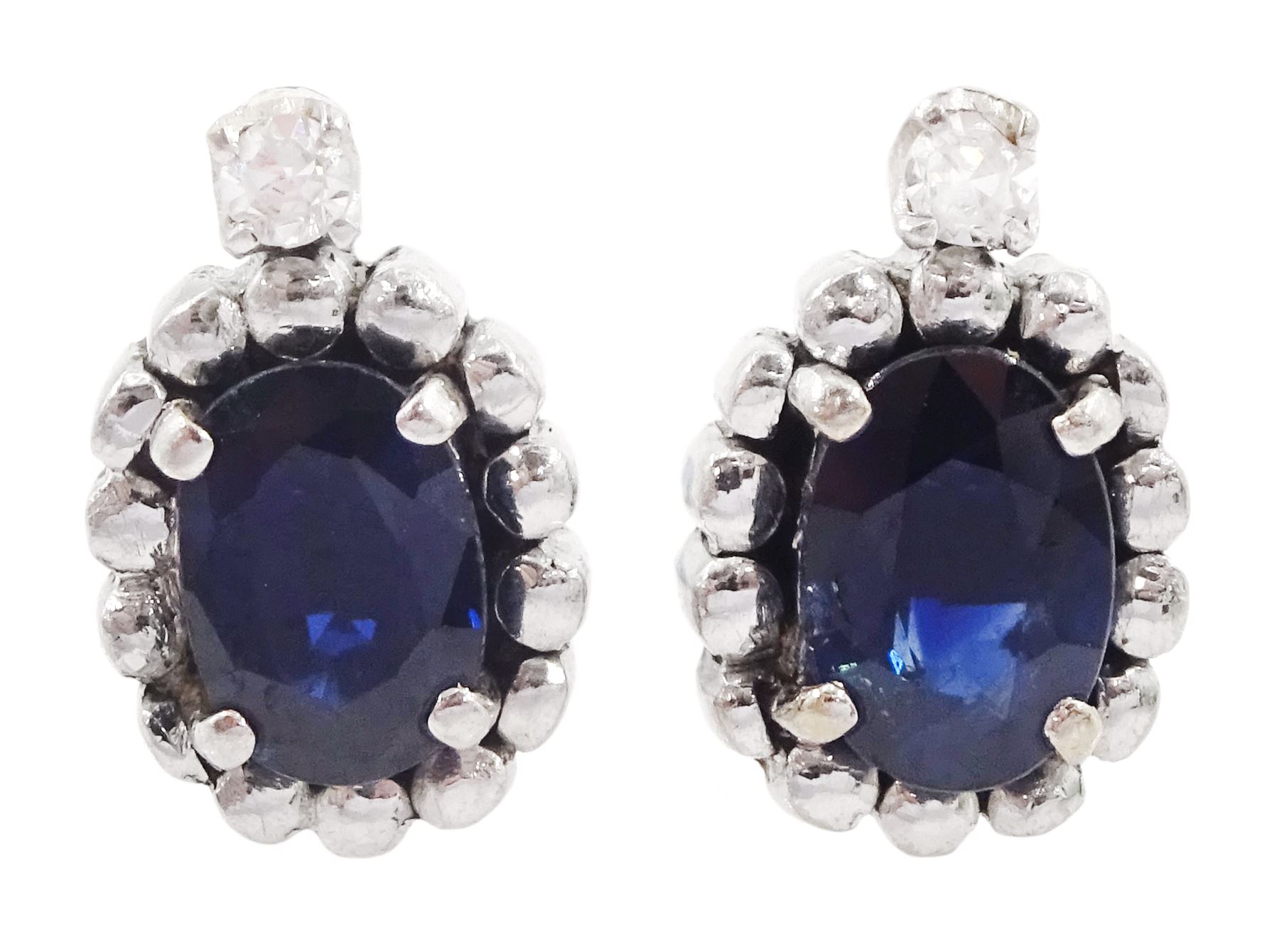 Pair of 14ct white gold oval cut sapphire and round brilliant cut diamond stud earrings