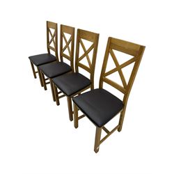 Oak extending dining table, square pull-out action top with folding butterfly leaf, on straight square supports; set of four dining chairs, X-shaped backrest and black upholstered seat, on square supports united by H-stretcher