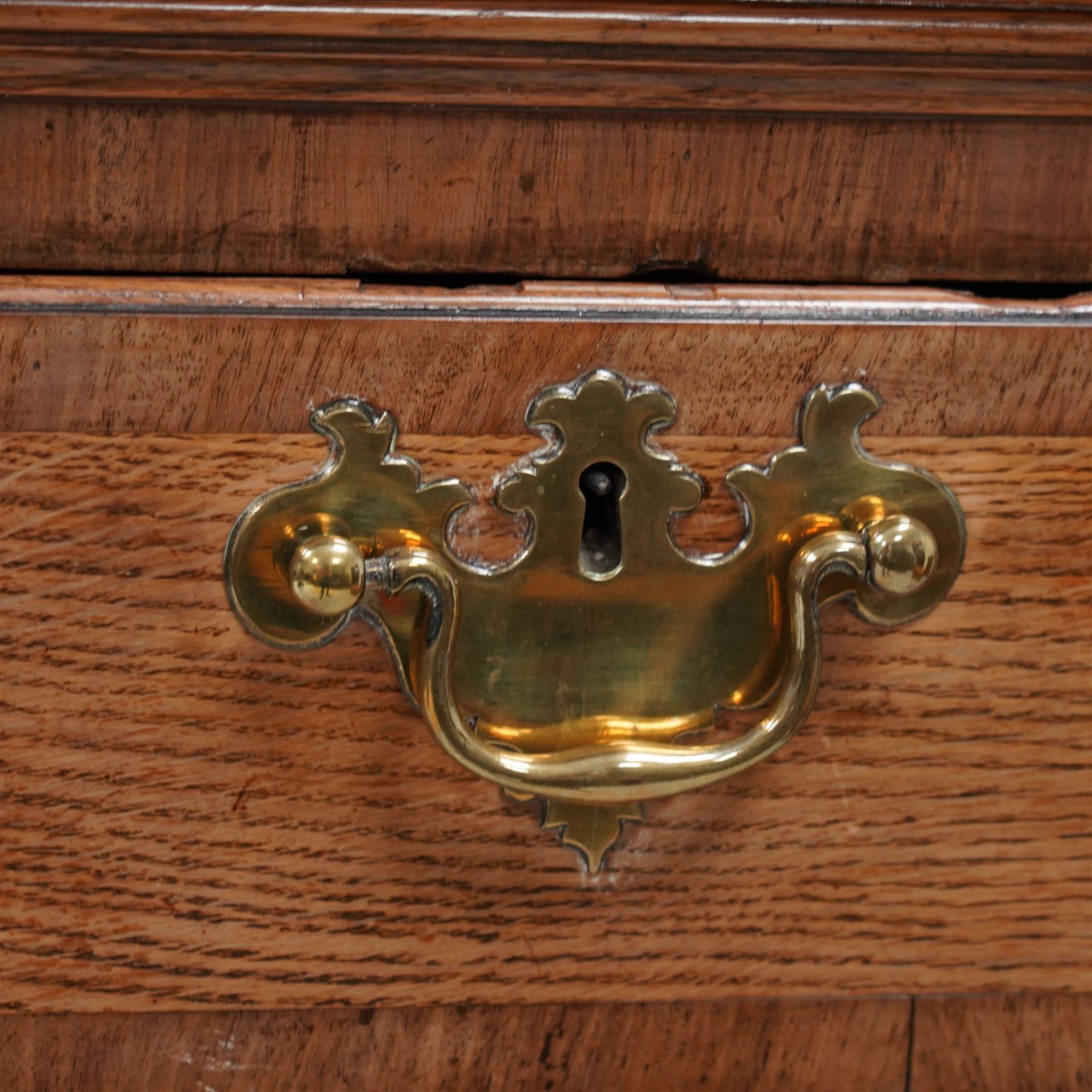 George III oak and mahogany banded chest on stand, moulded cornice over two short and three long drawers, shaped brass handle plates and swan neck handles, enclosed by canted corners with turned quarter columns, the stand fitted with three drawers, on bracket feet