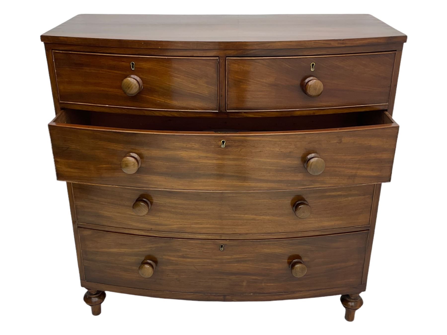 Early 19th century mahogany bow front chest, fitted with two short and three long drawers, turned feet