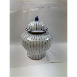 Large Oriental design ginger jar and cover, of squat baluster form with domed cover, decorated in blue with Chinese characters against a white crackle glaze ground, the cover, neck and foot rim with applied brass band, with character mark beneath, H43cm