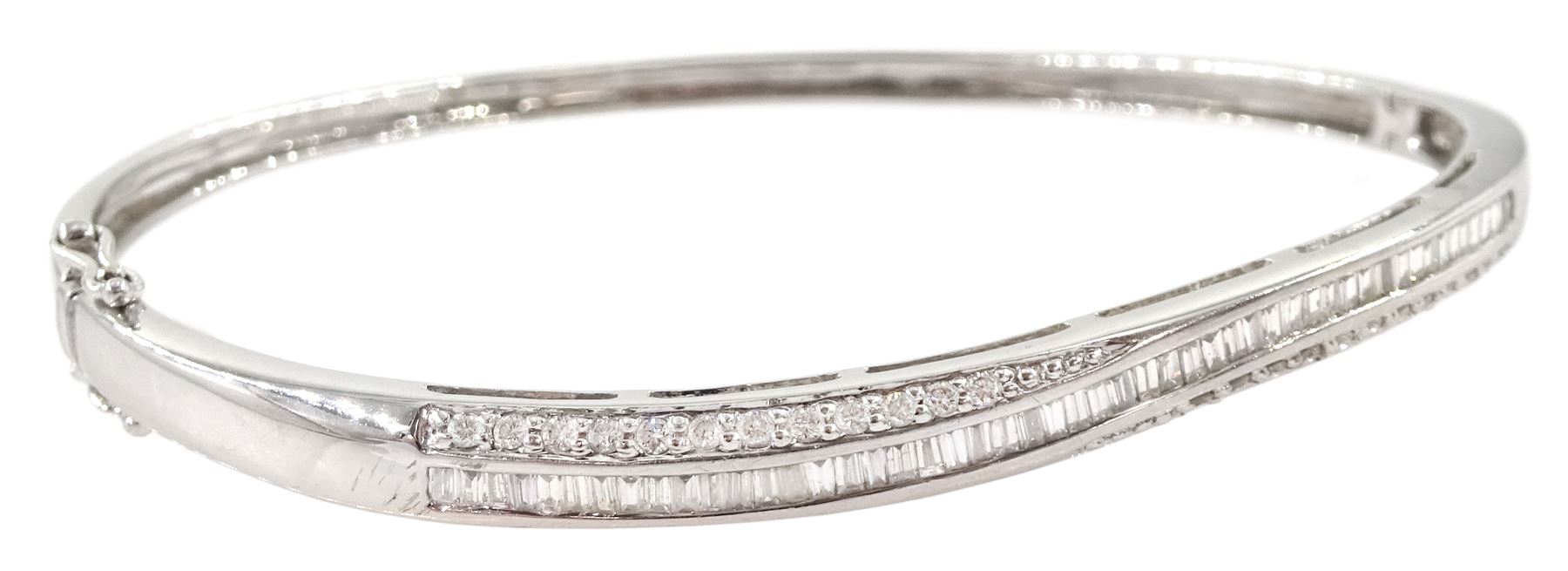 18ct white gold channel set round brilliant cut and baguette cut diamond twist bangle, Sheffield 2002, total diamond weight approx 1.00 carat