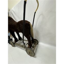 1920s/30s Panurge Pets push-a-long horse, with brown mohair body and white face, horse hair mane and tail and leather hooves, mounted upon a metal with rubber and metal wheels, including handle H71cm