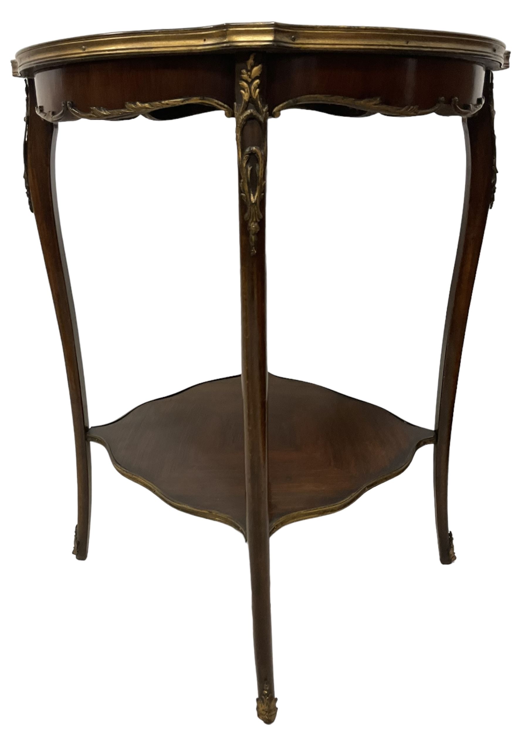 Early 20th century French two-tier marquetry inlaid walnut side table, shaped circular top with gilt metal edge, central chequered inlaid circular panel with floral motif, raised on cabriole supports with gilt metal mounts, united  by undertier