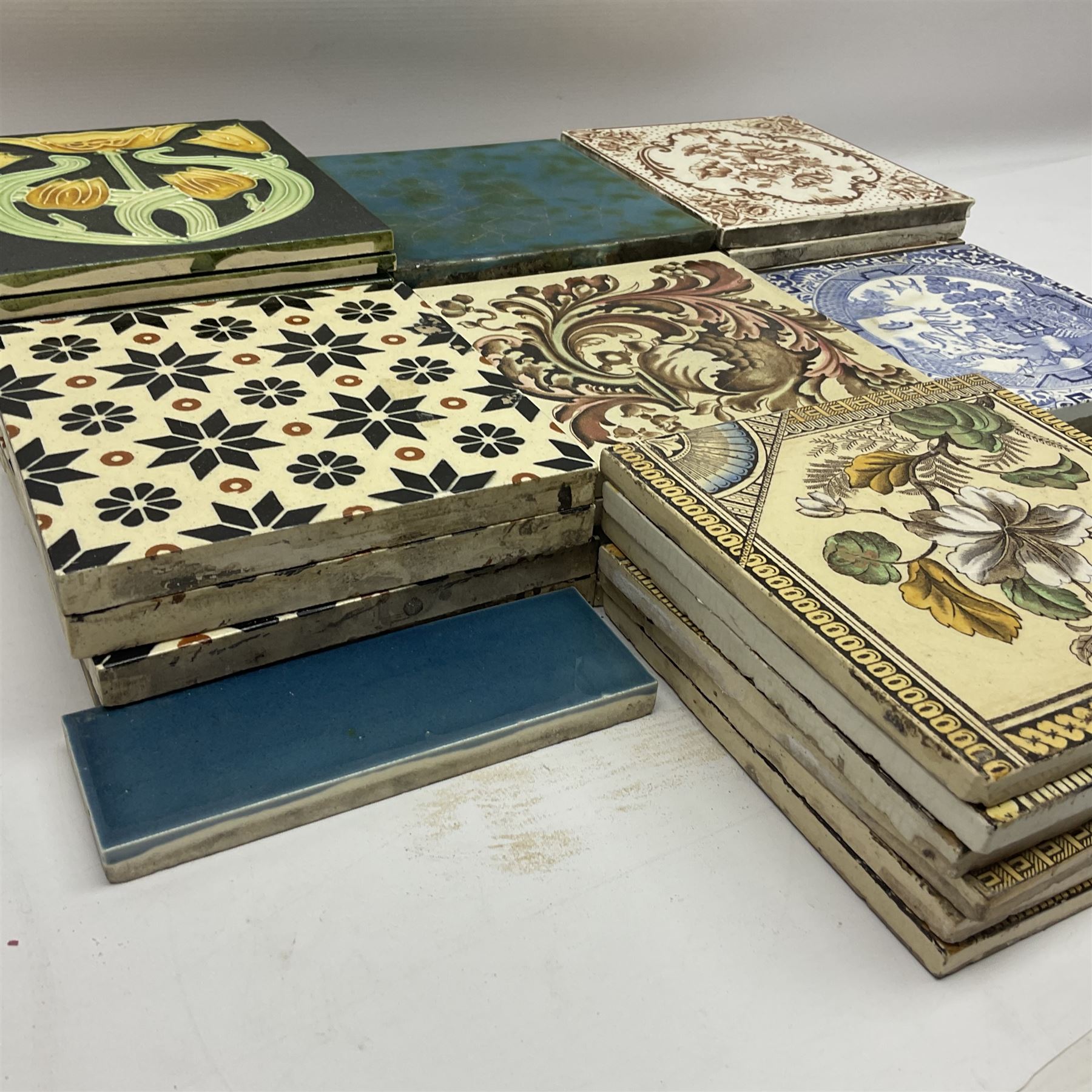 Collection of Victorian and later tiles to include floral and tube line examples