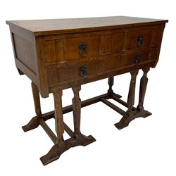 Arts & Crafts design oak chest on stand, rectangular top over two short and one long drawer, on a series of shaped and tapered supports with carved and beaded decoration, united by chamfered stretchers rails, on sledge feet 