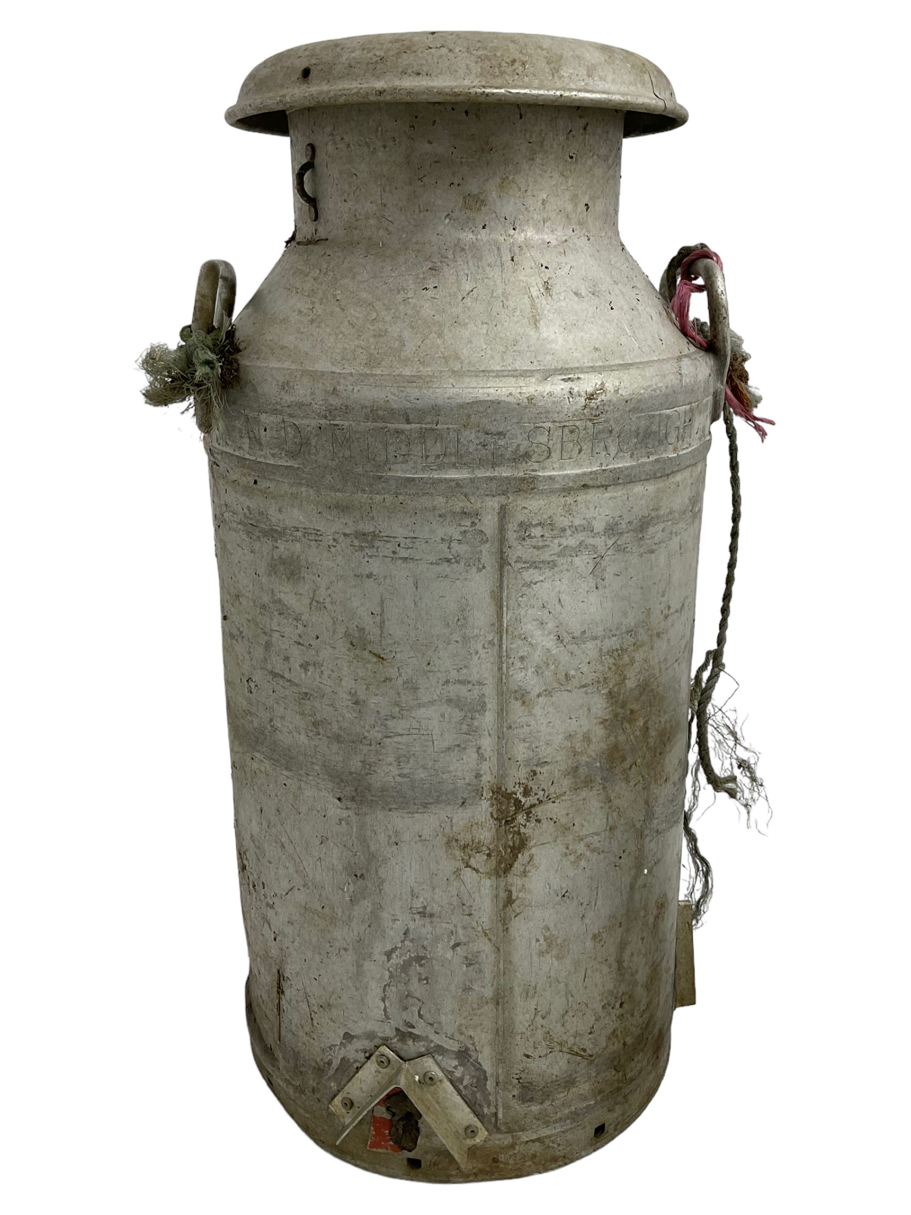 Near pair of antique aluminium milk churns with twin handles, one with Grundy Teddington lid