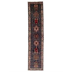 Persian indigo ground runner, the field decorated with nine medallions, surrounded by latt...