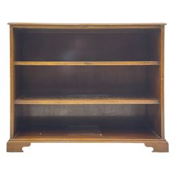 20th century mahogany open bookcase, fitted with two shelves, on bracket feet