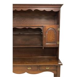 Early 20th century Georgian design oak dresser, projecting cornice with shaped apron over a three-tier plate rack with flanking fielded spice cupboards, the base fitted with three drawers, on turned supports