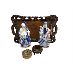 Chinese carved wooden tray, the rim carved as two dragons amidst clouds, D58.6cm, together with two Chinese blue and white Fu Lu Shou figures, each modelled as a sage, H30.5cm, a Japanese Satsuma box and cover, D10.5cm, and a small Chinese carved wooden stand, H6cm top D9.5cm