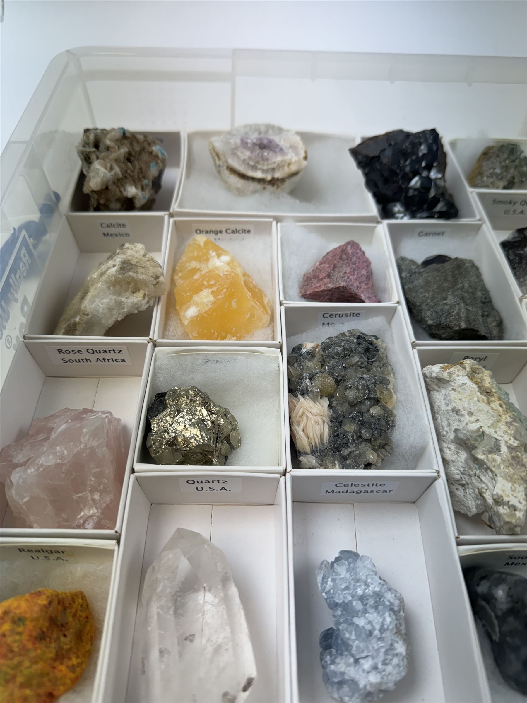 Collection of twenty-three mineral specimens, including orange calcite, realgar, conichalcite etc 
