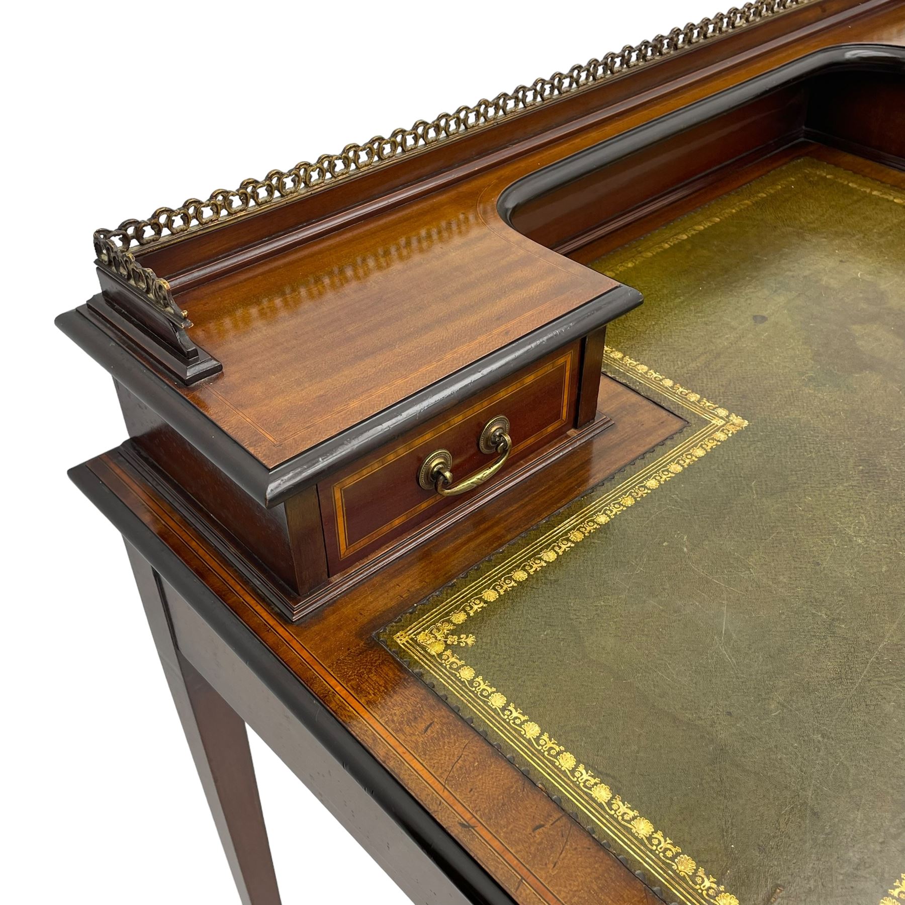 Edwardian inlaid mahogany writing desk, raised back with gilt metal gallery over two small drawers with satinwood banding, the rectangular moulded top with green leather inset writing surface, fitted with two drawers, on square tapering supports with spade feet, brass and ceramic castors 