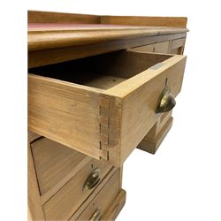 20th century oak desk, moulded rectangular top with raised back and inset leather writing surface, fitted with five drawers and single panelled cupboard, on moulded plinth base